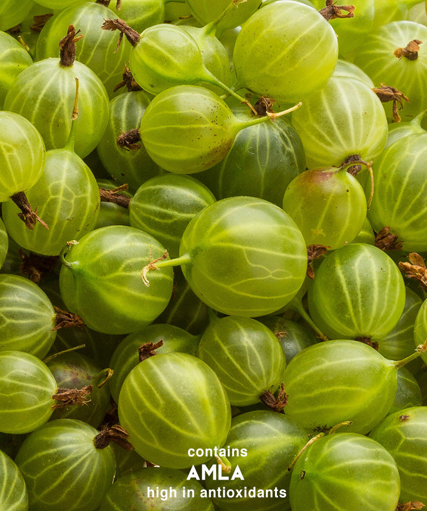 A close-up of green berries and fruits, embodying Surya Brasil's Henna Powder. Crafted from 100% natural ingredients for safe, vibrant hair coloring.