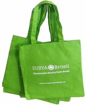 A green tote bag with white text, made of eco-friendly woven polypropylene material. Ideal for shopping or everyday use.